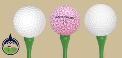 3 golf balls on tees with different dimple patterns