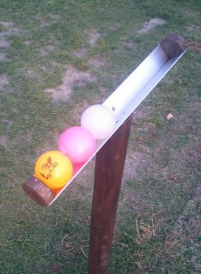 Three brightly colored park golf balls